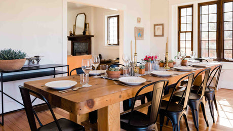 A-large-wooden-dining-table-with-black-chairs-in-a-dining-room