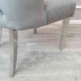 Modern-grey-velvet-lion-knocker-dining-chairs-chrome-legs-quilted-back